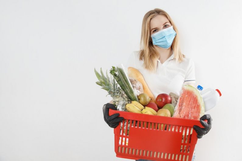 Online Groceries - woman in white long sleeve shirt holding red plastic basket with fruits