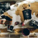 Travel Insurance - black DSLR camera near passport