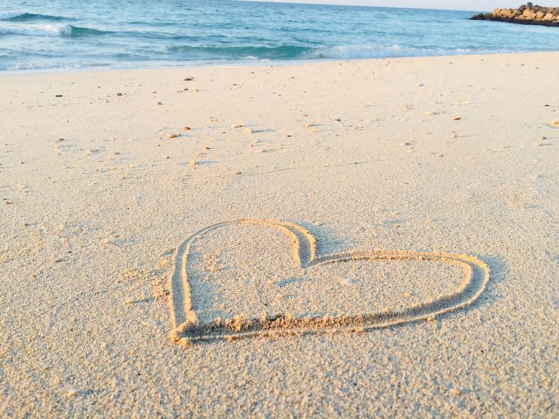 Relaxing Beaches - heart drawn on sand during daytime