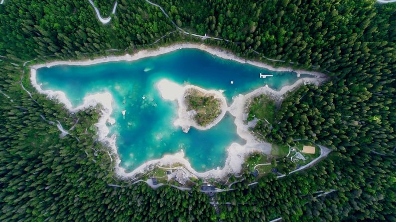 Jet Lag - aerial photography of body of water surrounded by trees at daytime