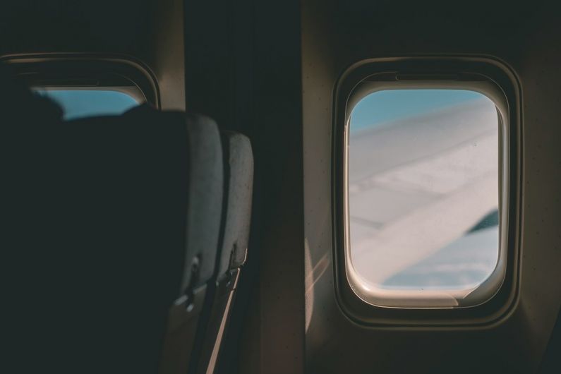 Volunteering Abroad - a view of the wing of an airplane through a window