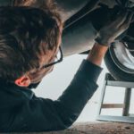Car Maintenance Importance - Man Fixing Vehicle Engine