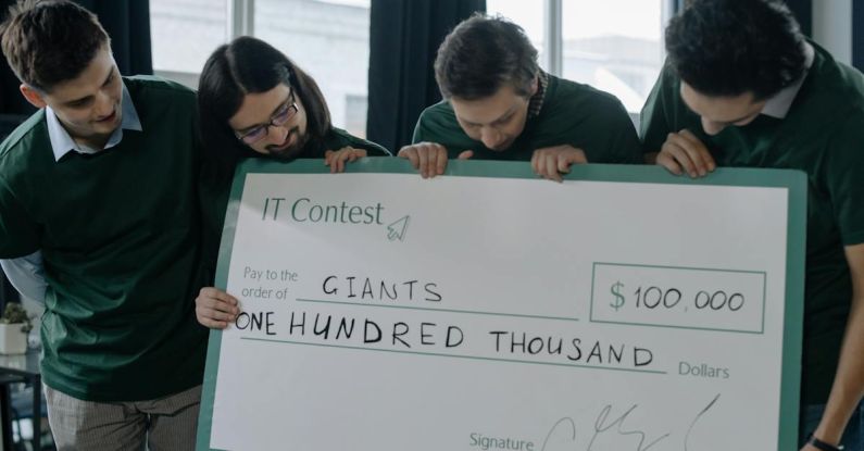 Startup Funding - Team Holding a Big Check Happy About Winning Additional Funding
