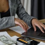 Cash Flow Management - A Woman in Plaid Blazer Using Her Laptop